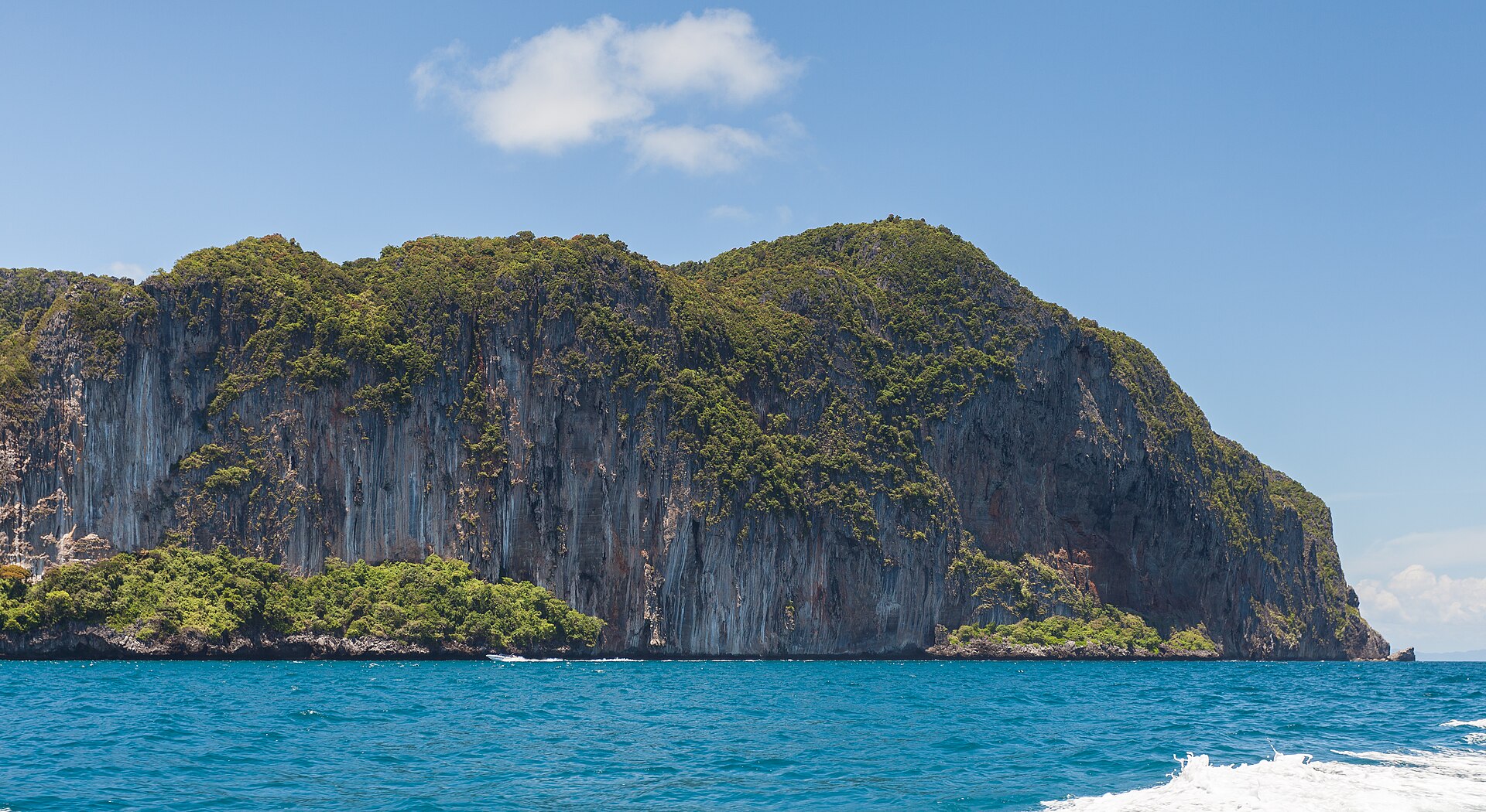 Limestone cliffs and longtail boats, Thailand